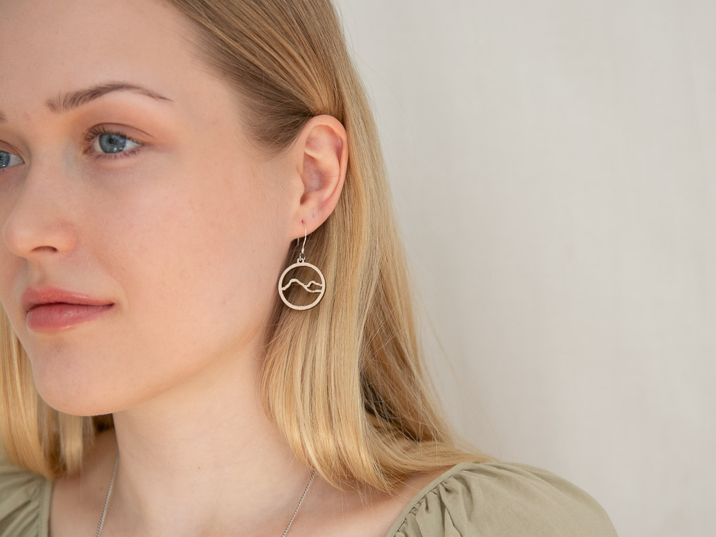 Woman wearing mountain earrings