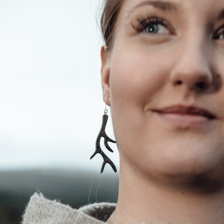 Smiling woman with black antler earring