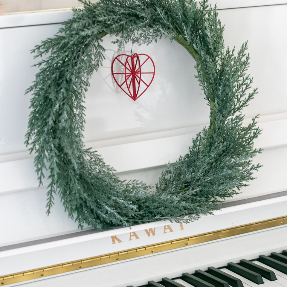 Red wooden heart by the piano