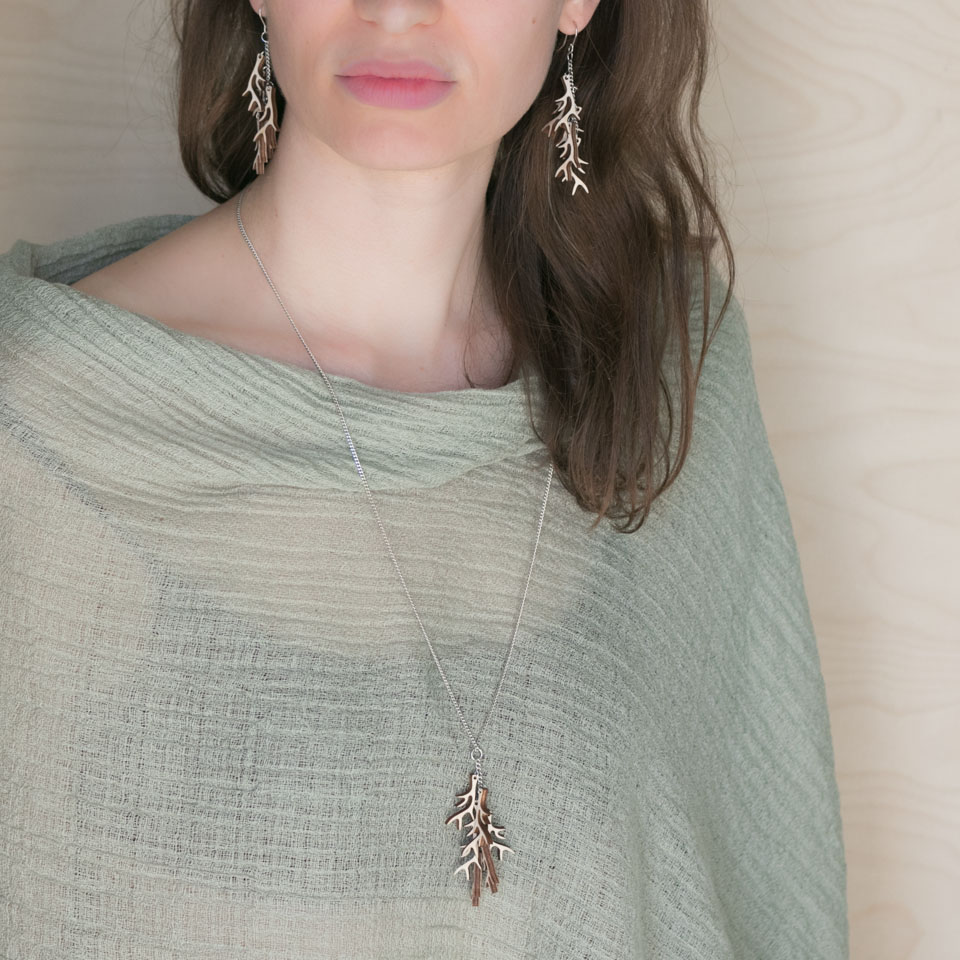 Brunette wearing wooden antler jewellery