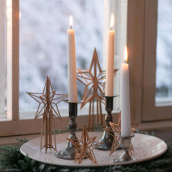 Wooden stars and candle setting by the window