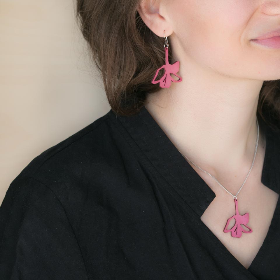Woman wearing pink Lily earrings and necklace