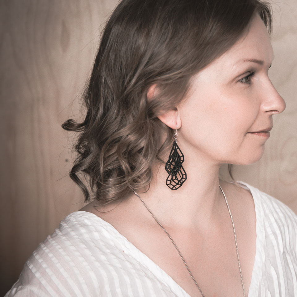 woman with black statement earrings