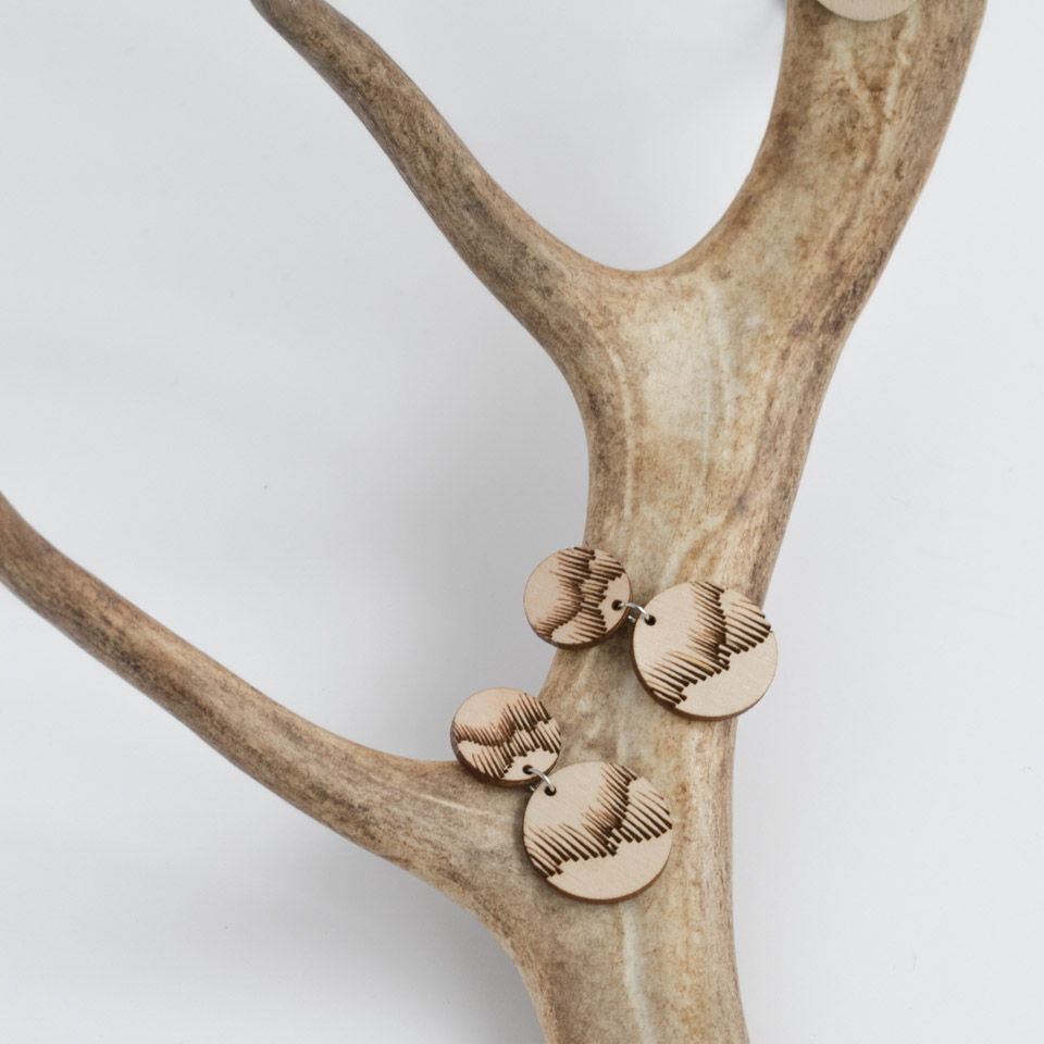 Valona Northern Lights wood earrings on reindeer antler