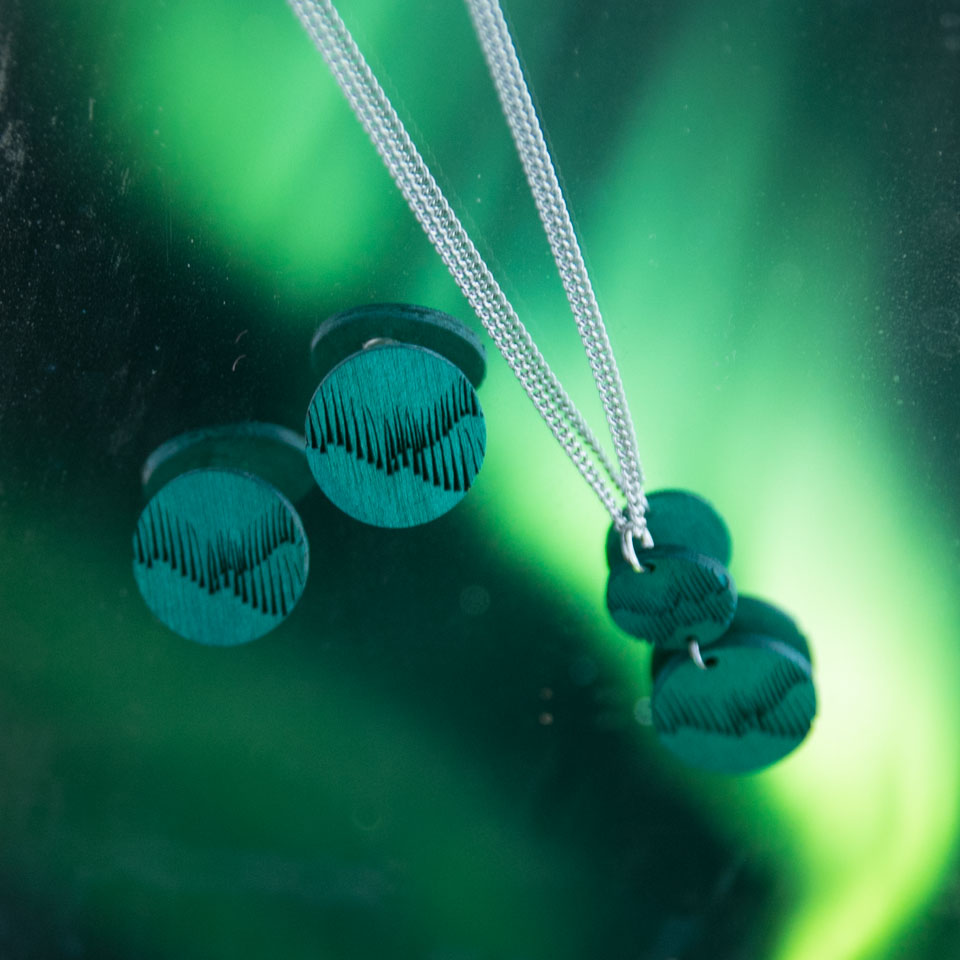 Northern Lights jewelry against Aurora borealis sky