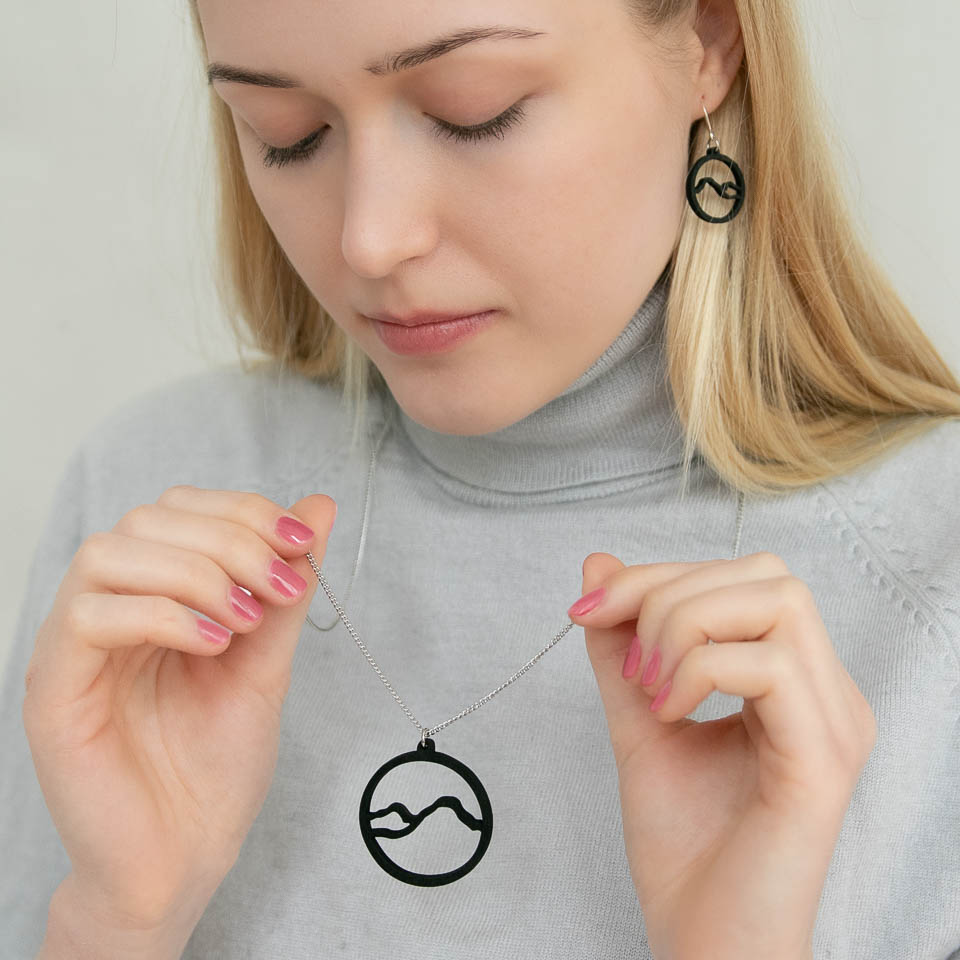Woman with black mountain earrings
