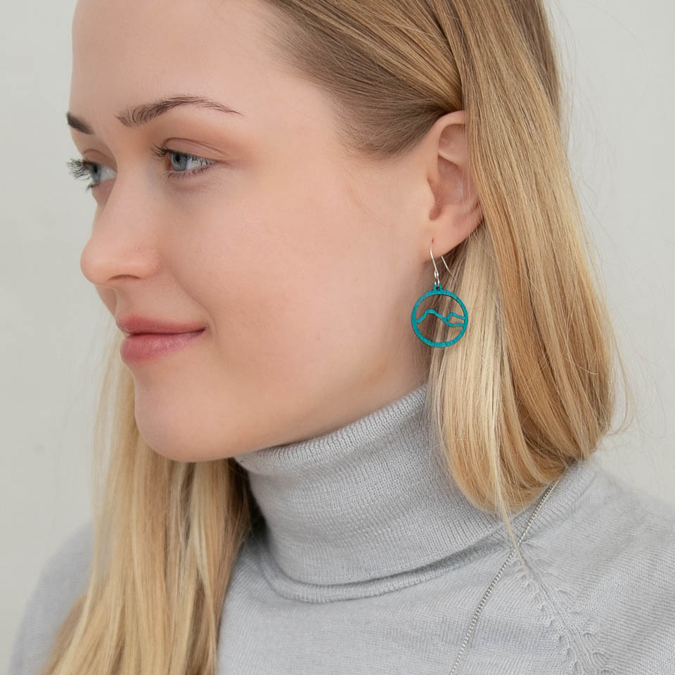 Woman wearing turquoise Lapland mountain earrings