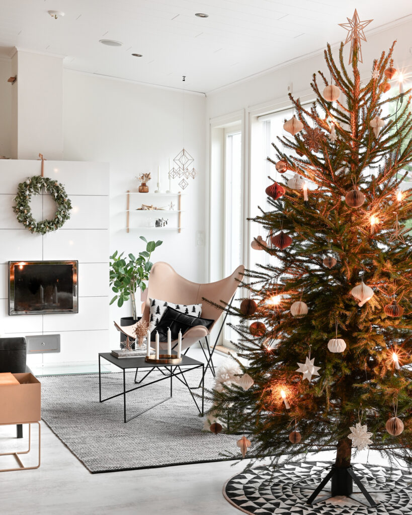 Nordic interior with wooden himmeli and Christmas tree with wooden star topper