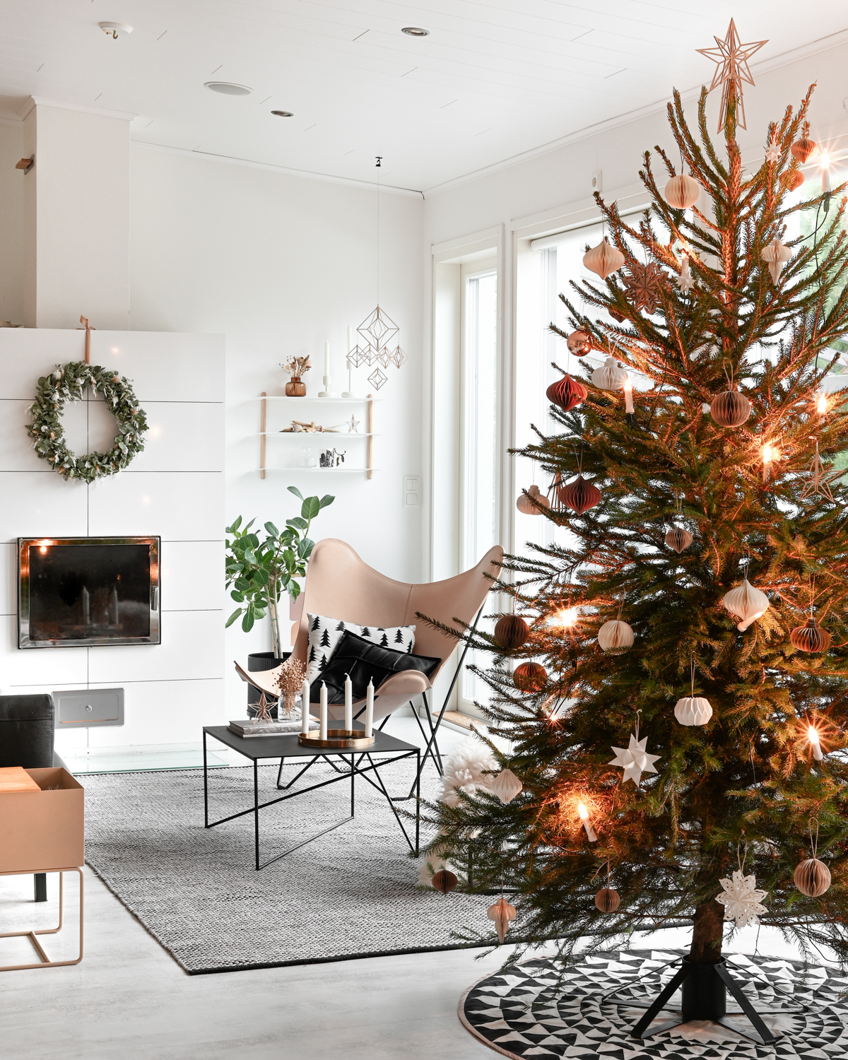 Nordic interior with wooden himmeli and Christmas tree with wooden star topper