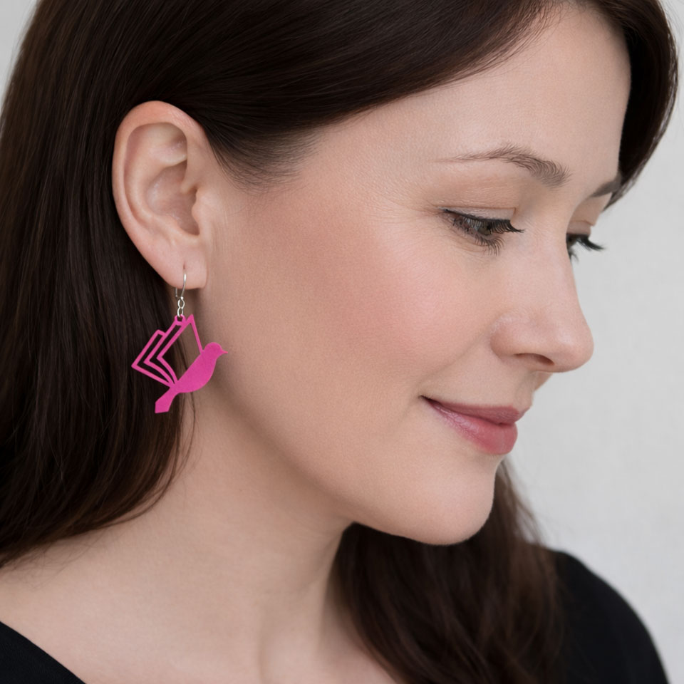 Woman with pink book bird earrings