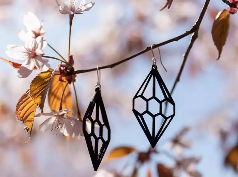 black wooden diamond earrings hanging on cherry branches