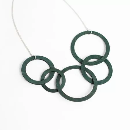 Green necklace with different sized hoops against white background