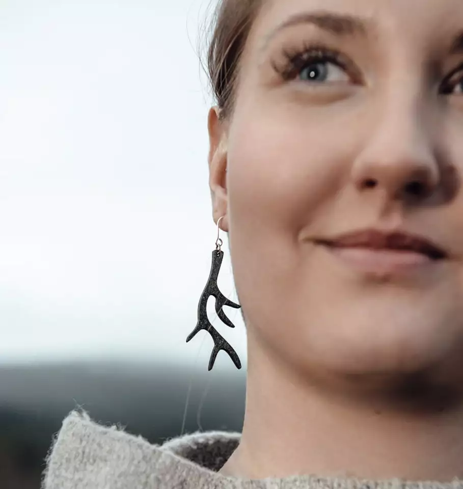 Smiling woman with black antler earring