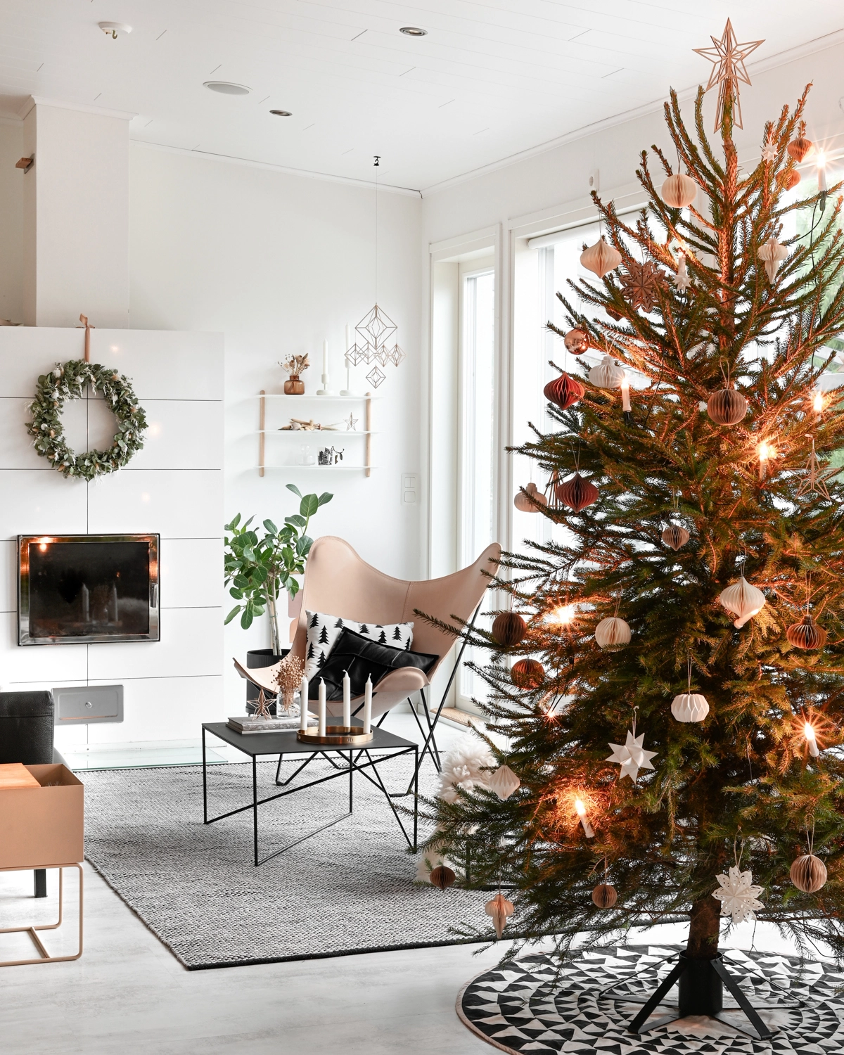 Nordic interior with wooden himmeli and Christmas tree with wooden star topper